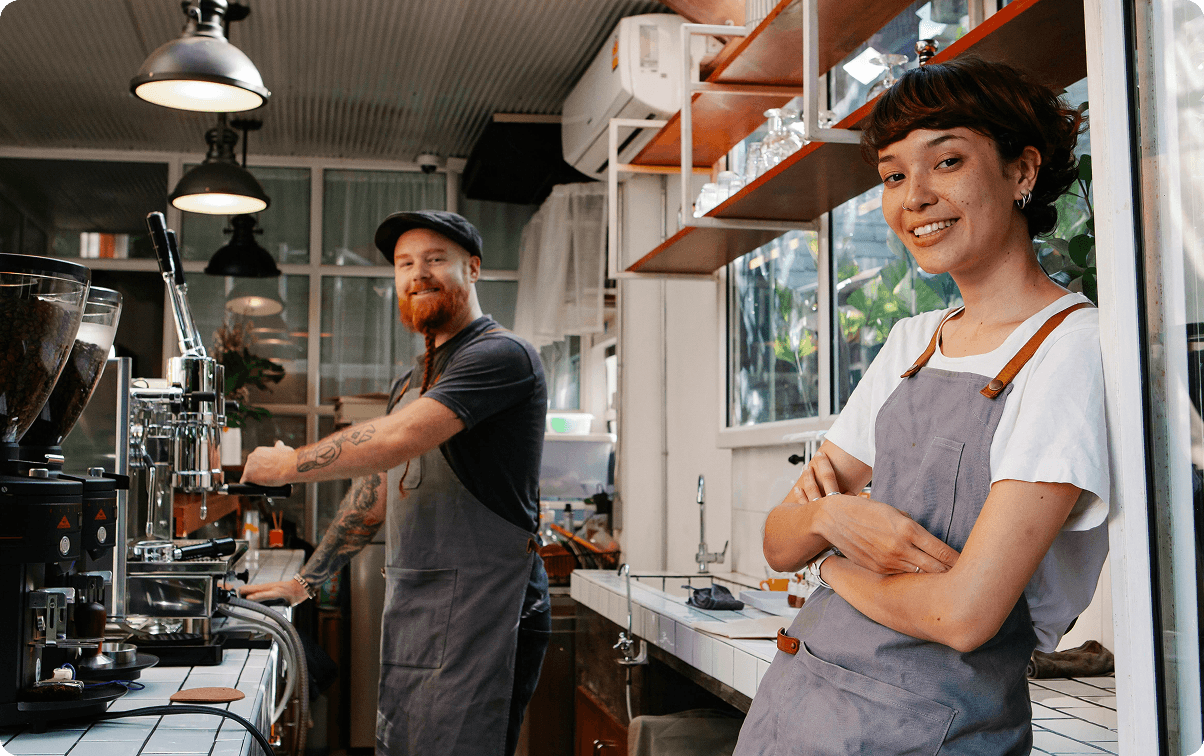 Restaurant kitchen interior with staff preparing food